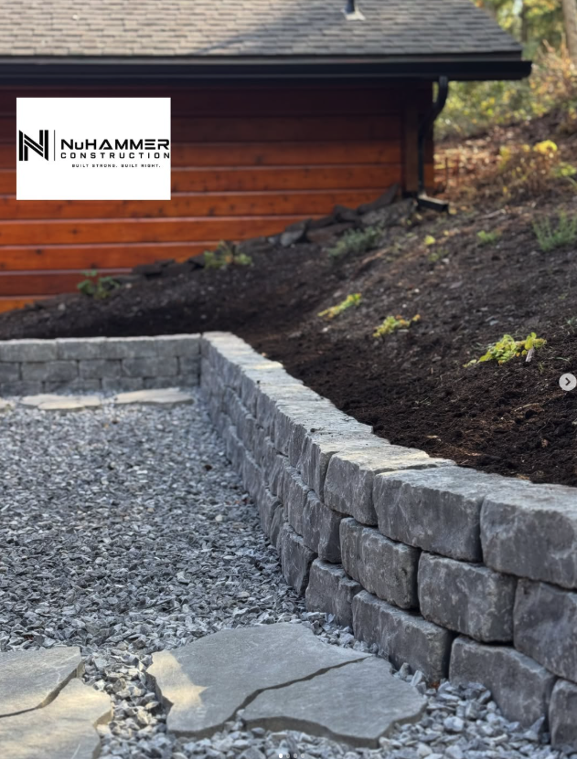 NuHammerConstruction completed outdoor stone retaining wall and gravel pathway